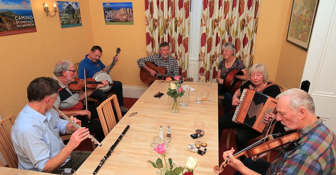 A group of people playing instrumentsDescription automatically generated